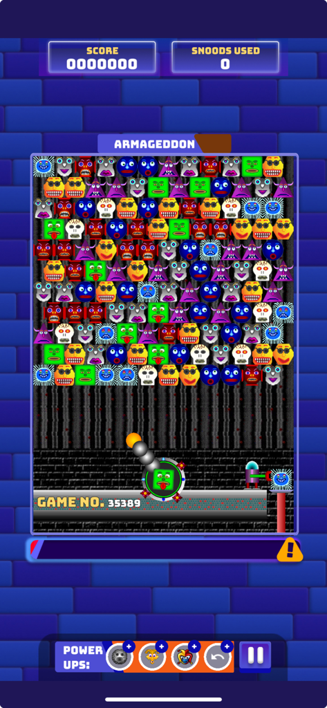 Gameplay of Snood Original showing colorful character faces in a puzzle grid with a launcher at the bottom