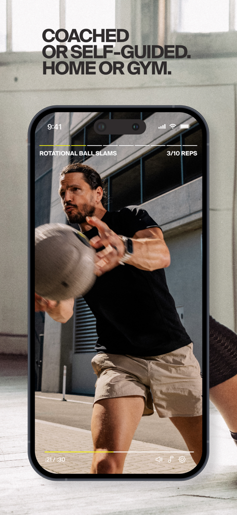 A trainer performing rotational ball slams in a Centr app workout video