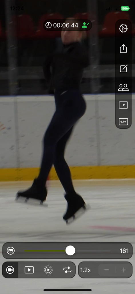 A figure skater mid-jump being analyzed frame by frame in the Coach Video Analyzer app interface