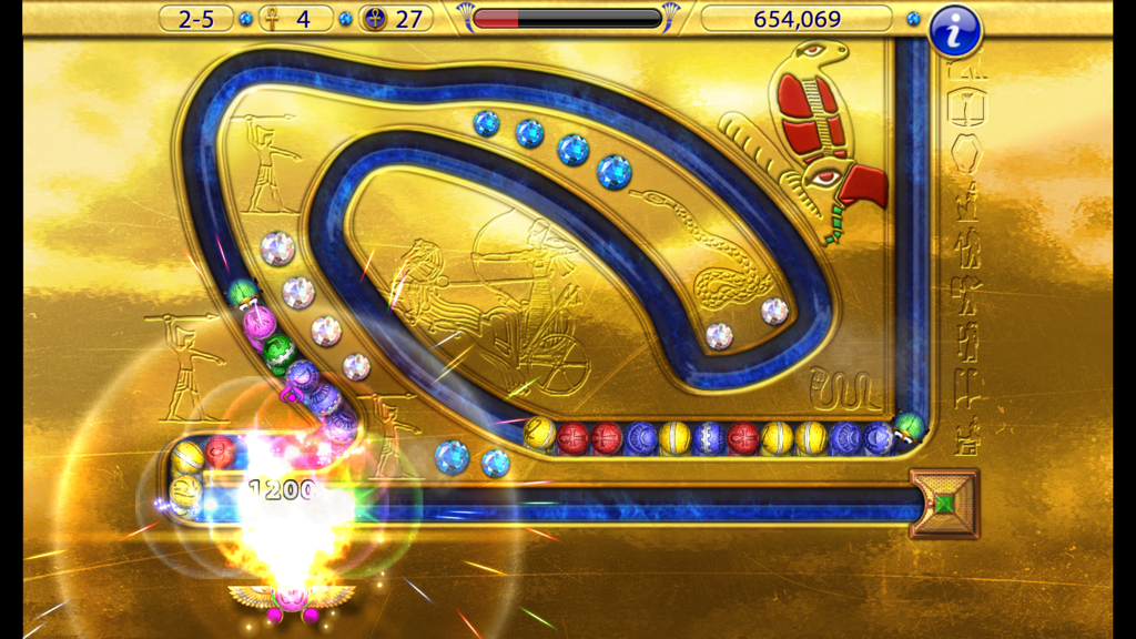 Gameplay screenshot of Luxor Amun Rising HD showing a marble shooter level with ancient Egyptian carvings and colored spheres.