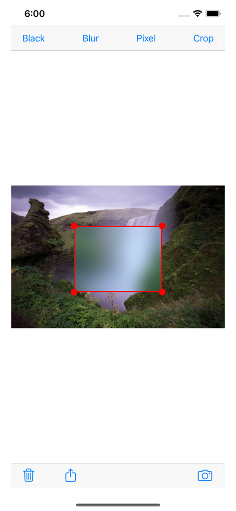 Screenshot of the Redacted app interface showing a rectangular blur tool applied to a landscape photo.