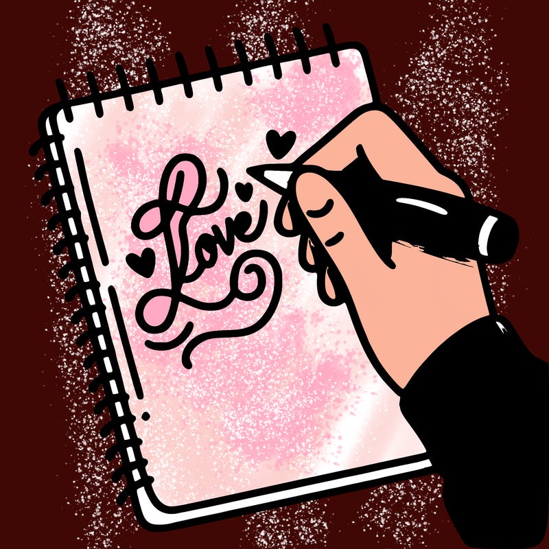 a hand writing “love” in calligraphy on a notebook