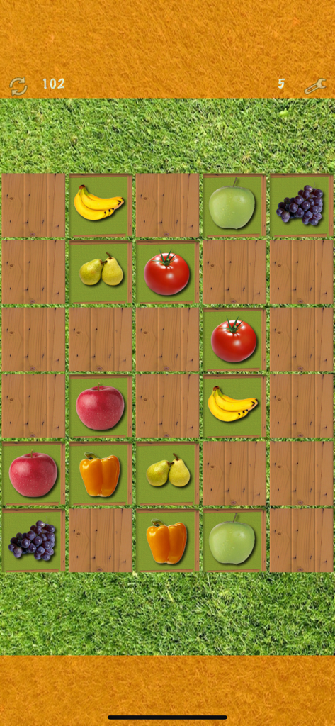 Pairs (Oh no! Another one!) - A memory matching game board with fruit icons on wooden tiles over a grass background.