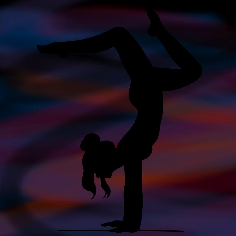 a woman doing a handstand