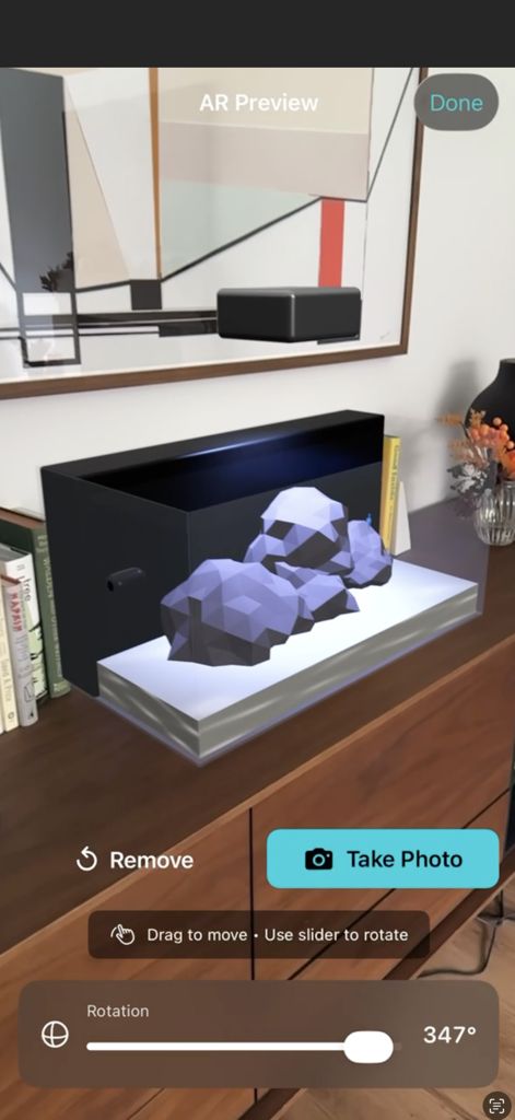 Aquarium Planner AR - Augmented reality preview of a 3D aquarium model placed on a room dresser.