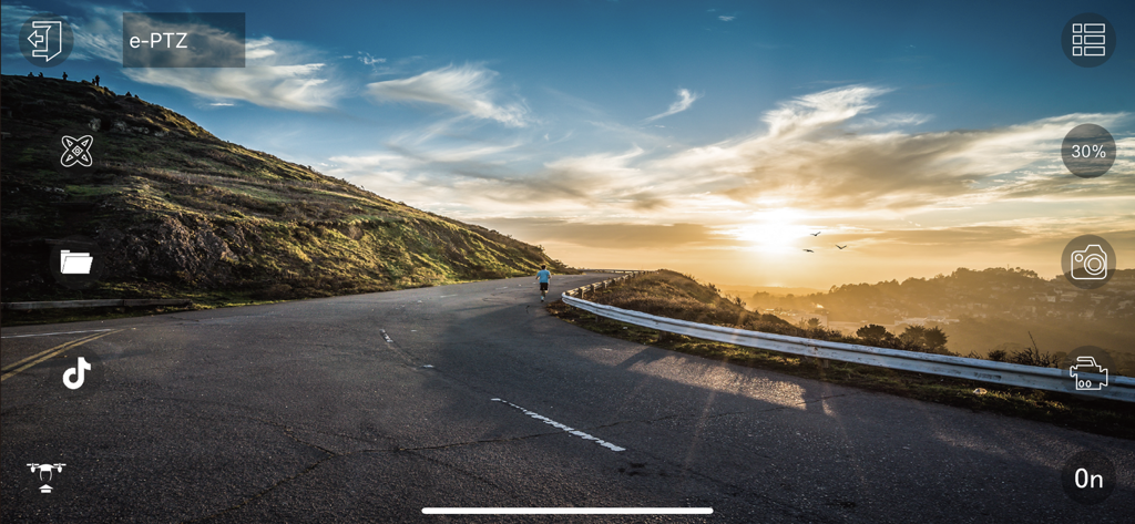 HF UFO - L'application HF UFO affichant un flux vidéo en direct du drone d'un coucher de soleil sur une route