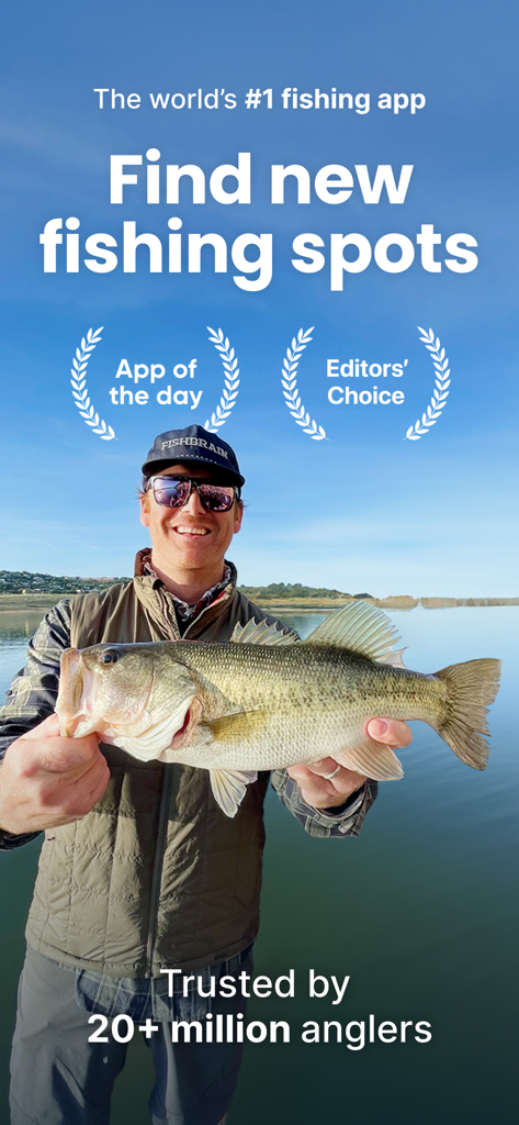 Fishbrain - Fishing App - An angler holding a large fish in front of a lake showcasing the Fishbrain app feature to find new fishing spots