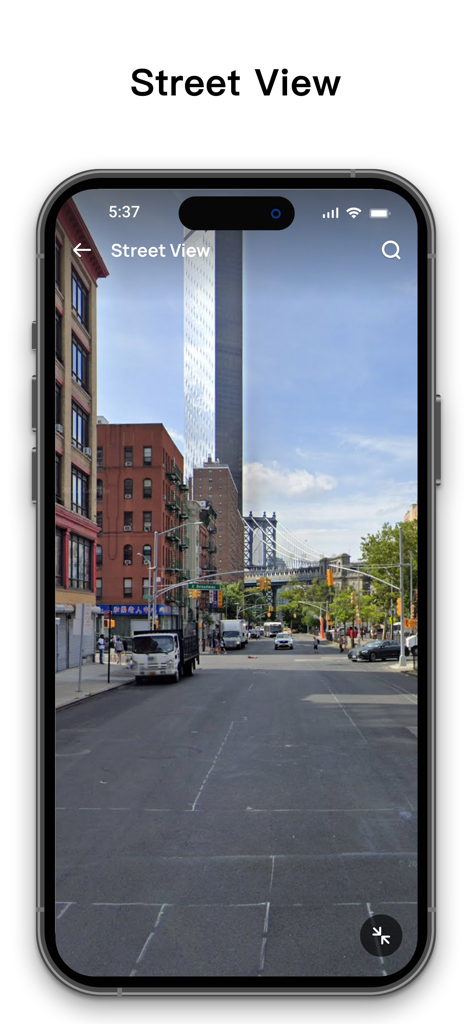A mobile app interface displaying a street view of a New York City street with buildings and the Manhattan Bridge in the background.
