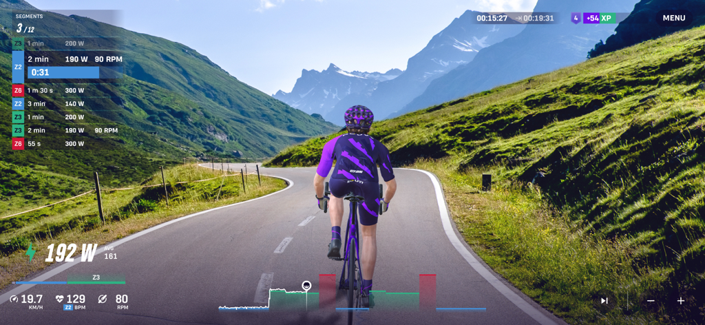 ROUVY app interface showing a cyclist on a real mountain road with training metrics and performance data