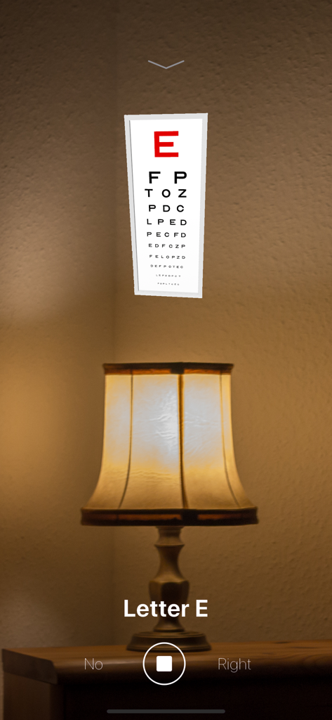 A Snellen eye chart displayed in augmented reality on a wall above a lamp.