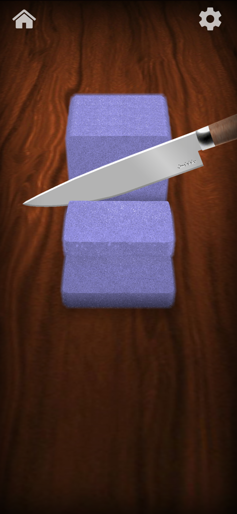 A digital kitchen knife cutting through a purple block of textured sand on a wooden table.