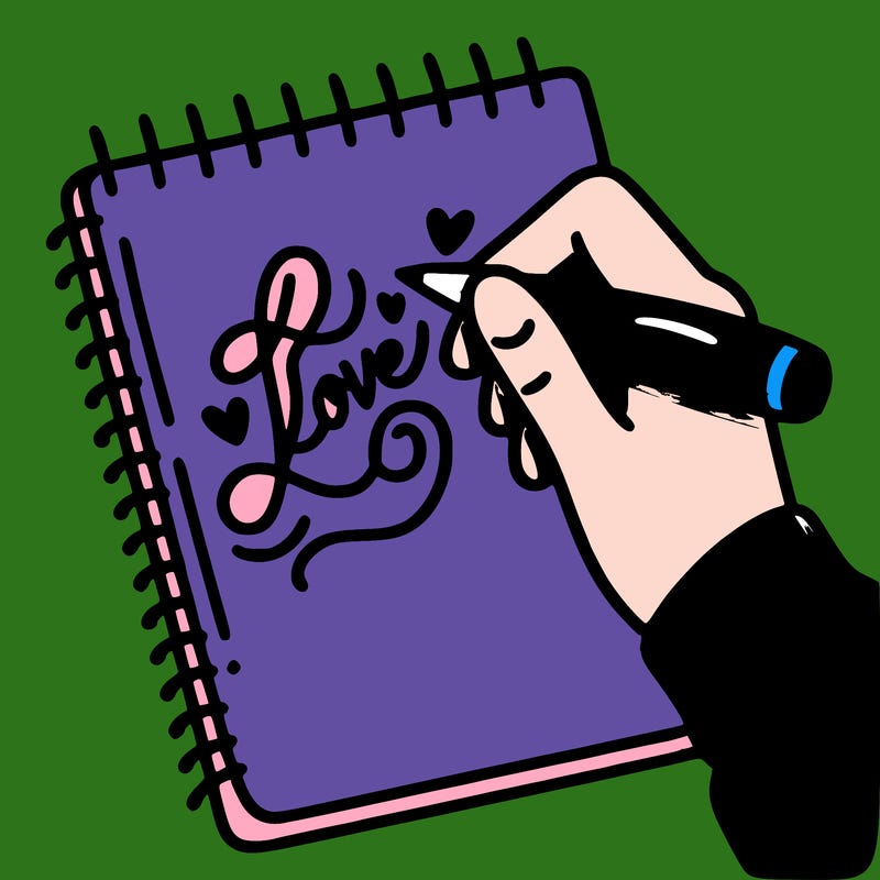 a hand writing “love” in calligraphy on a notebook