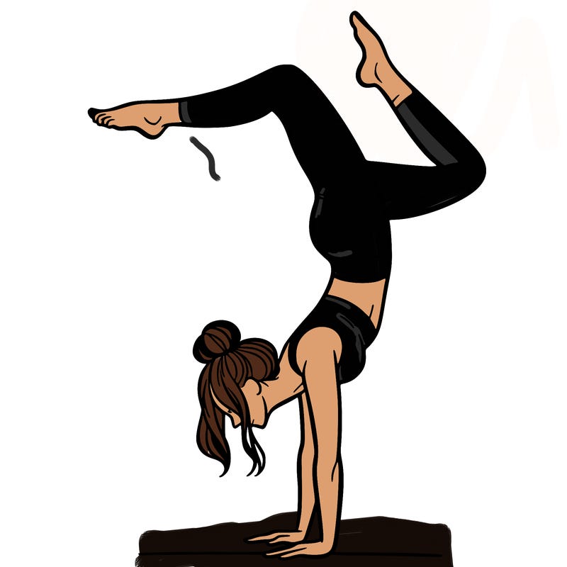 a woman doing a handstand