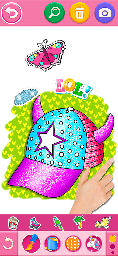 A child coloring a glittery cap with stickers in a mobile coloring game