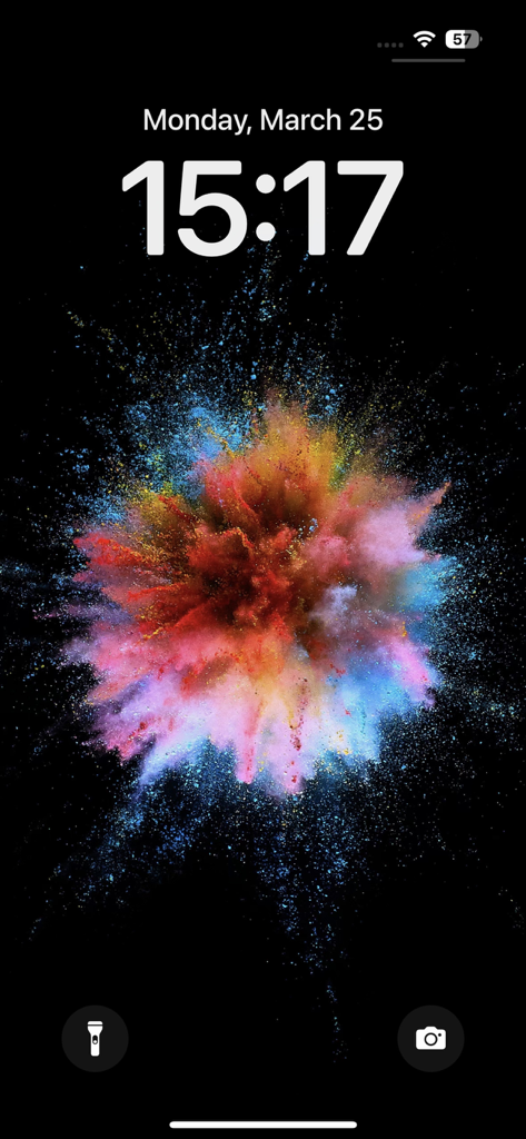 Vibrant colorful powder explosion wallpaper on an iPhone lock screen
