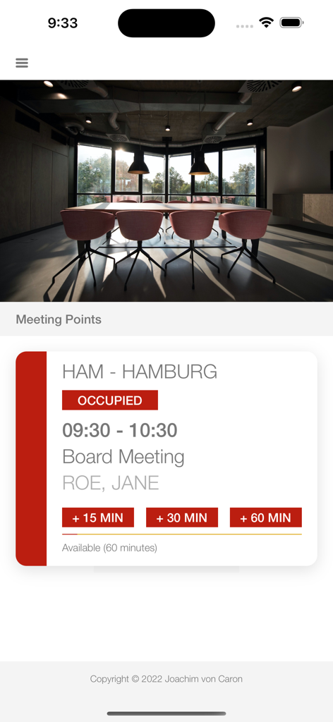 iPhone screen showing an occupied conference room status for a board meeting with extension options