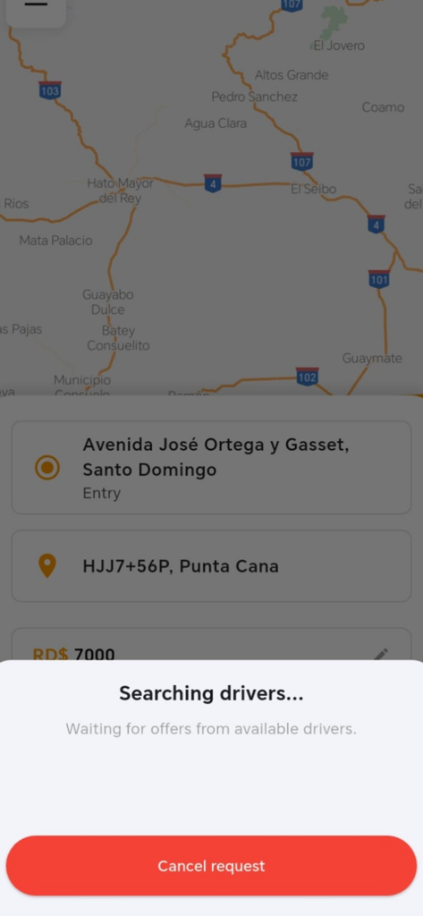 A mobile interface of the Punta Cana Rides Lux app showing a map and a pop-up window with the status Searching drivers and a cancel request button.