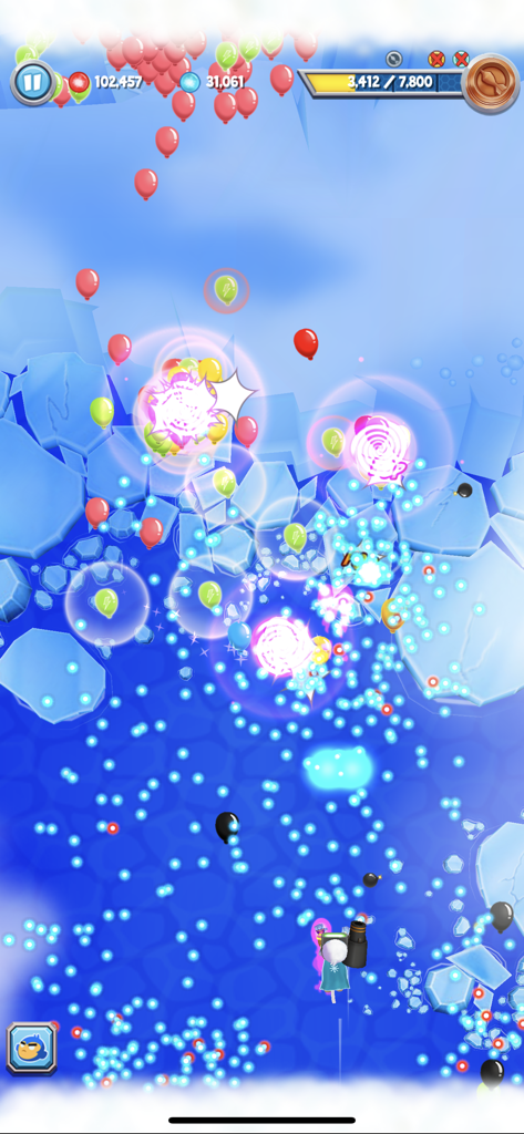 Fast paced gameplay of Bloons Supermonkey 2 showing a monkey shooting colorful balloons on an icy background.