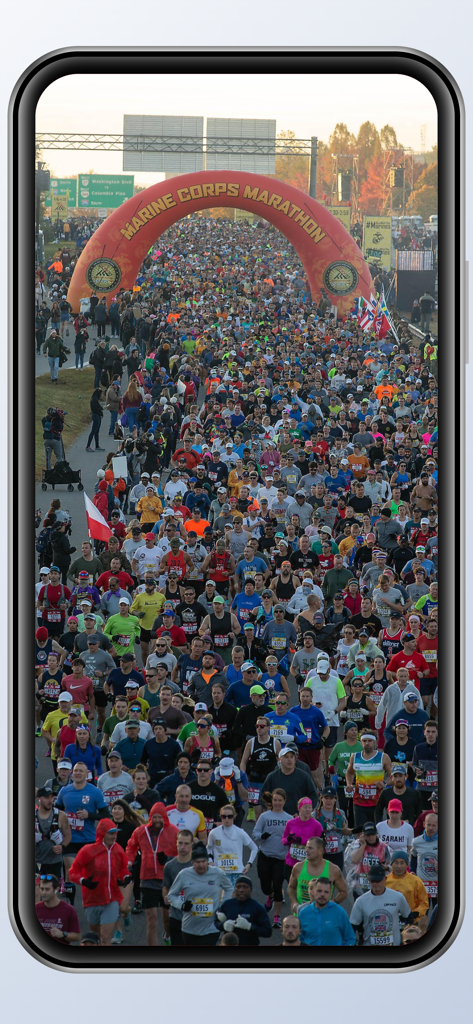 MCM Organization - Thousands of runners crossing the start line under the Marine Corps Marathon arch