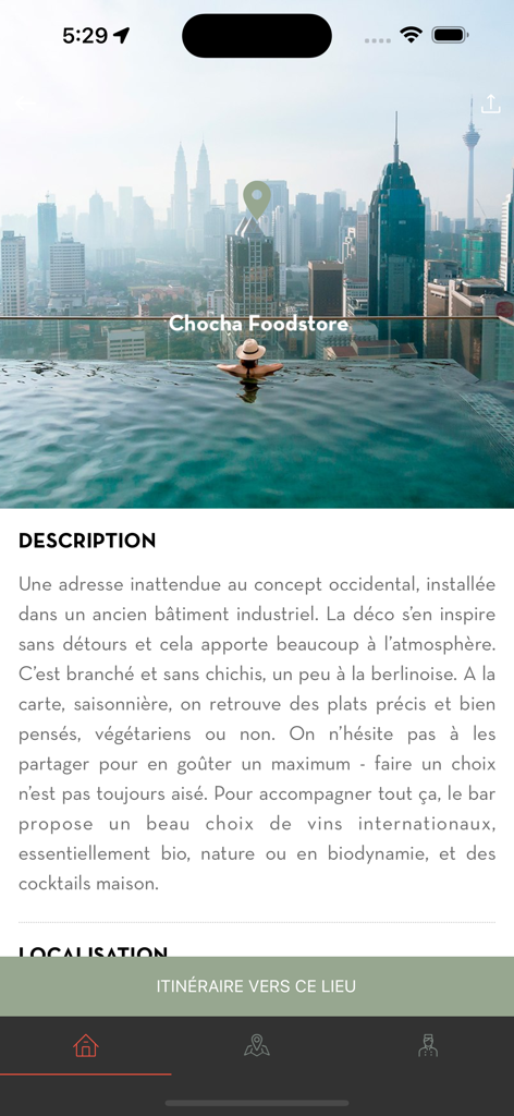 Voyageurs du Monde - Interface of the Voyageurs du Monde app showing a curated restaurant recommendation with a city skyline and infinity pool background.