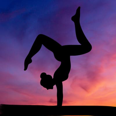 a woman doing a handstand