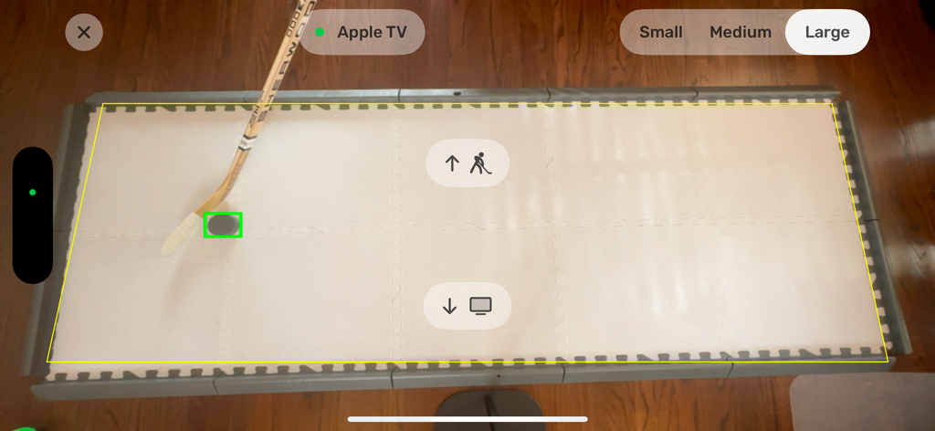 Dangleverse - Overhead iPhone view of a hockey puck and stick being tracked for augmented reality training