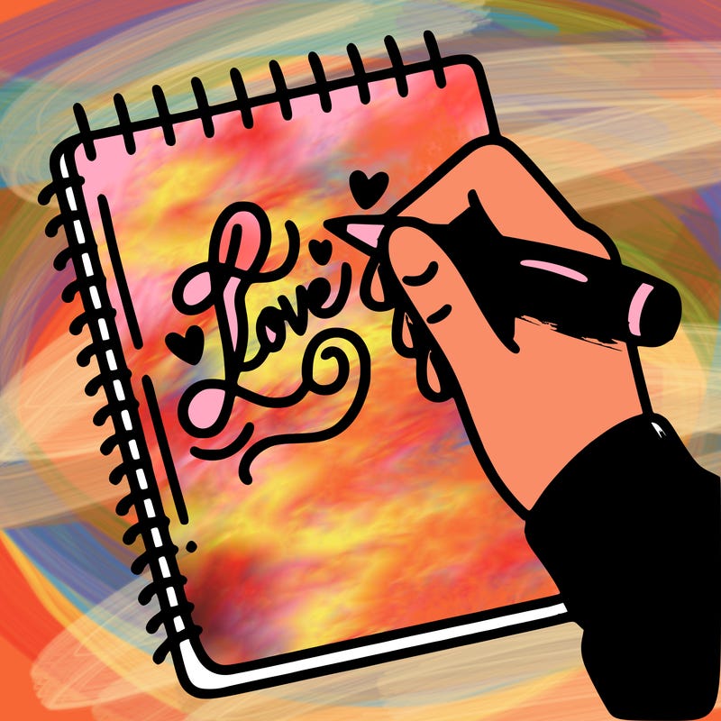 a hand writing “love” in calligraphy on a notebook
