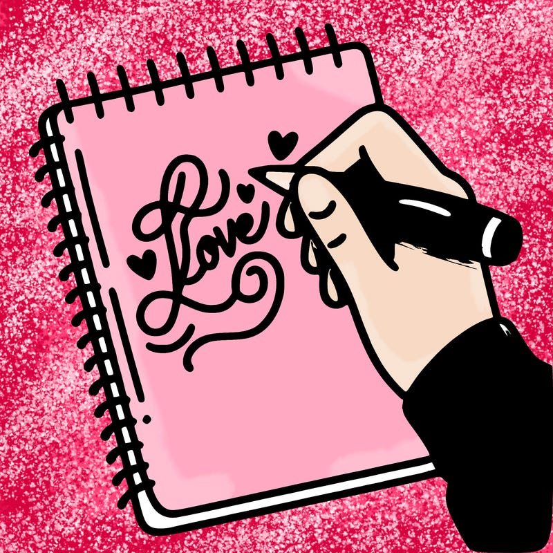 a hand writing “love” in calligraphy on a notebook