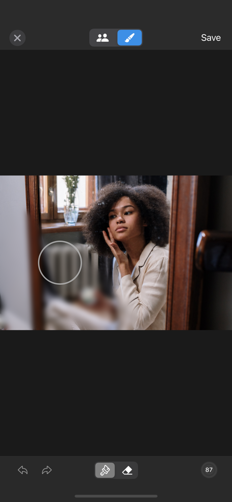 BlurFace - A screenshot of the BlurFace app manual editor showing a brush tool blurring a background radiator in a portrait photo.