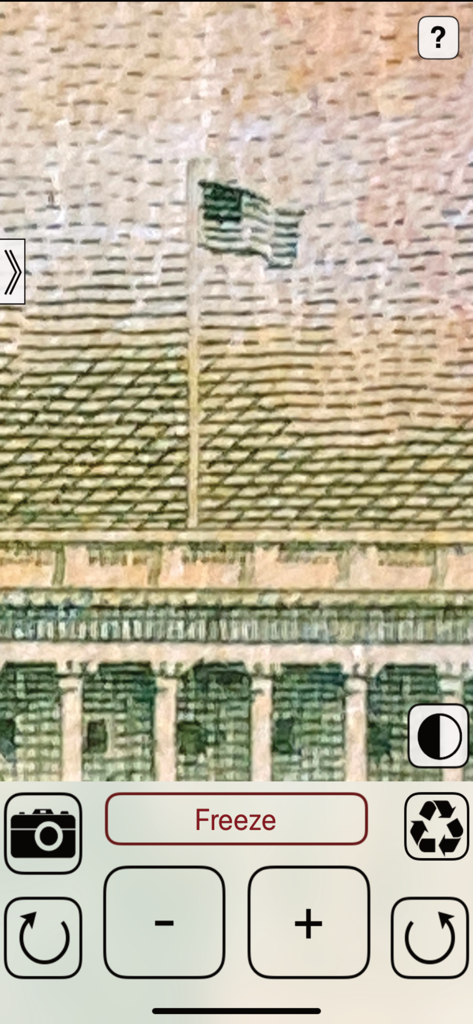 Interfaz de aplicación de lupa digital mostrando una vista de alta magnificación de una pequeña bandera