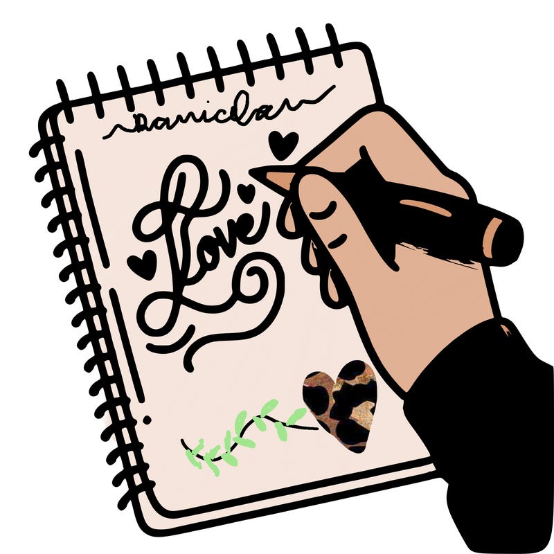 a hand writing “love” in calligraphy on a notebook
