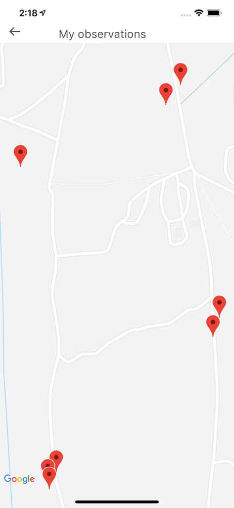 PlantNet - A map screen within the PlantNet app displaying red pins marking locations of recorded plant observations