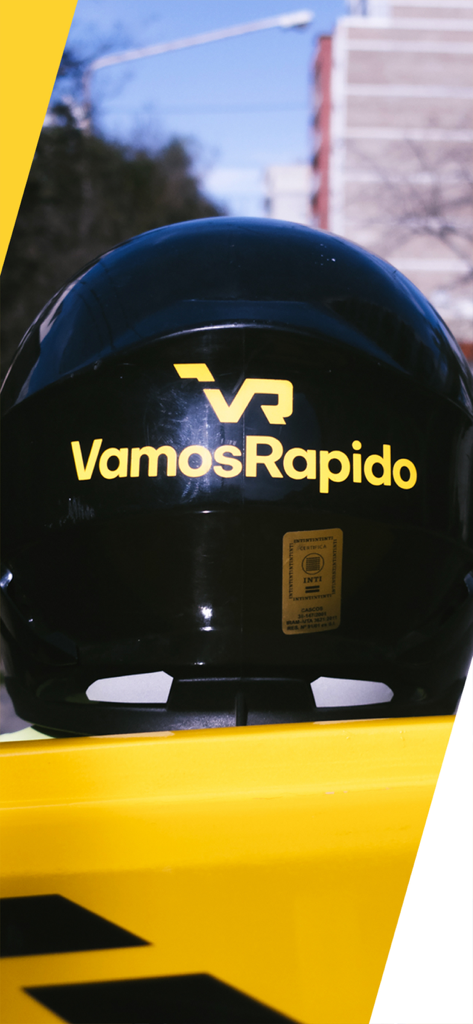 A black motorcycle helmet with the yellow Vamos Rapido branding logo