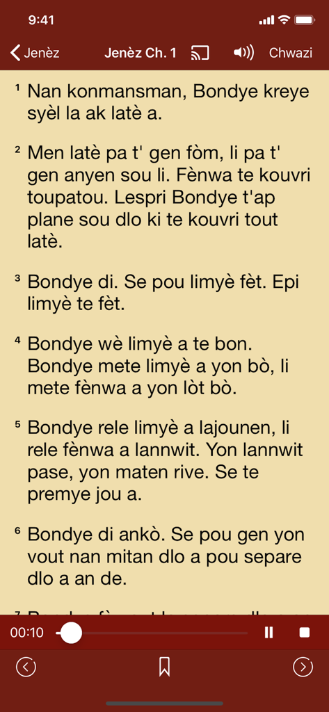 Haitian Creole Bible app interface showing the first chapter of Genesis with audio playback controls.