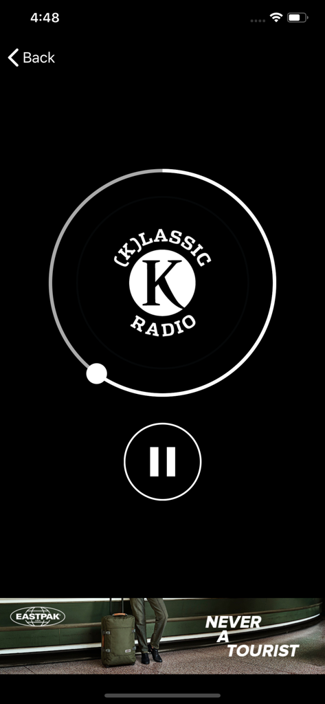 Mobile app player interface for Klassic Radio featuring a pause button and circular progress bar