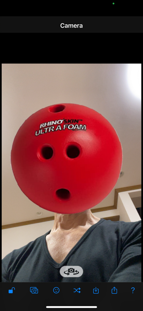 AR Mask - A person using the AR Mask app to wear a red bowling ball as a face mask