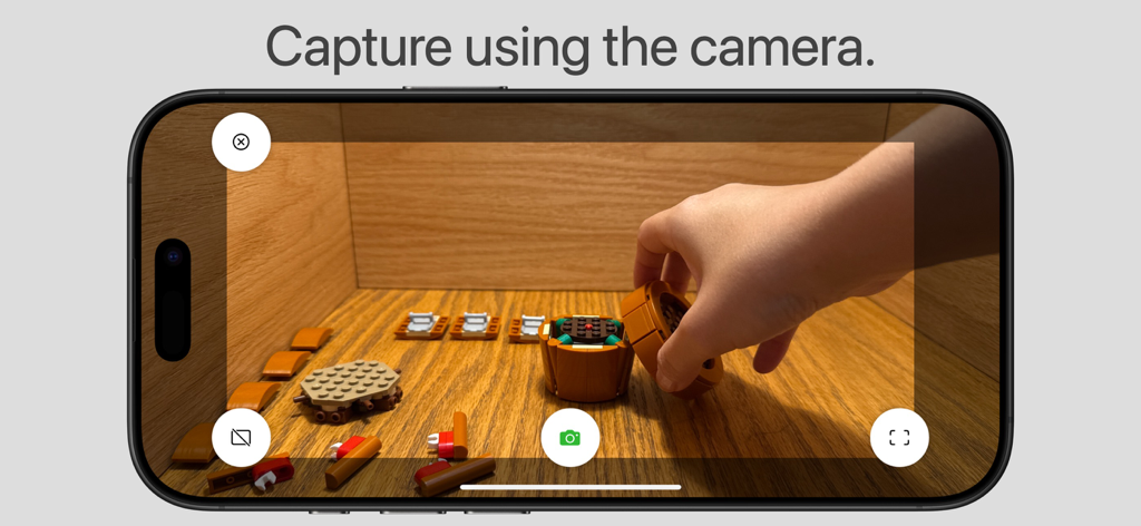 Stop Motion Stitcher - A person using the Stop Motion Stitcher app camera to capture frames for a LEGO animation on an iPhone.