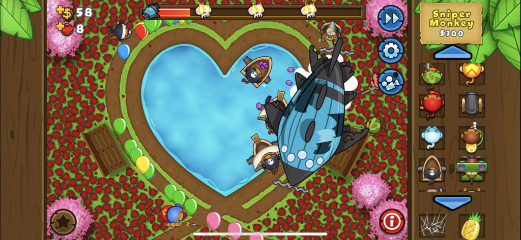 Captura de pantalla del juego Bloons TD 5 de torres atacando un dirigible ZOMG en una pista con forma de corazón