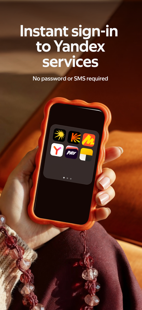 Yandex ID (ex-Key) - A hand holding a smartphone displaying the Yandex ID app screen showing various service icons for instant passwordless sign in.