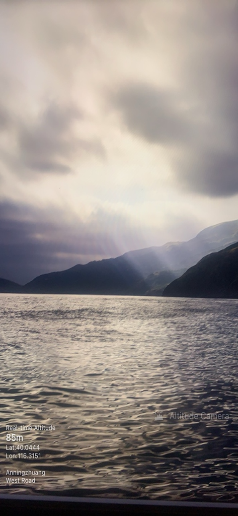 Altitude Camera app photo showing real time altitude and location data over a mountain landscape