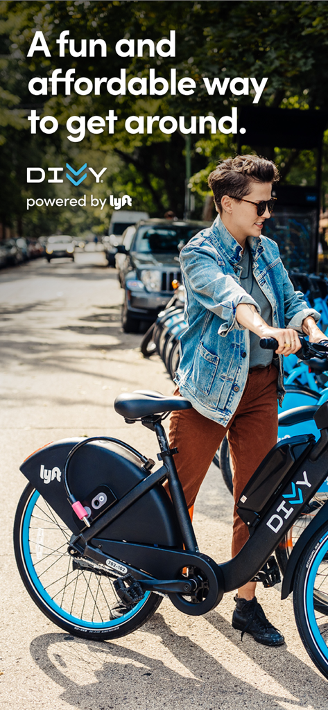 Divvy Bikes - A person standing with a Divvy bike on a city street