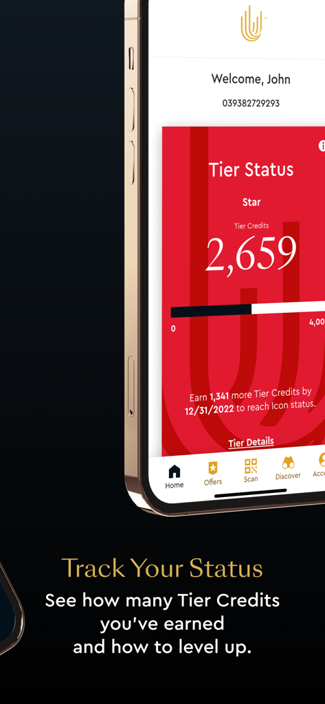 Unity by Hard Rock - Unity by Hard Rockアプリが表示された携帯電話、会員ティアのステータスと獲得クレジットの進捗状況を表示