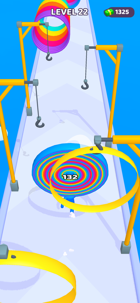 Un personaje de muelle colorido recogiendo anillos amarillos en una pista en Layer Man 3D