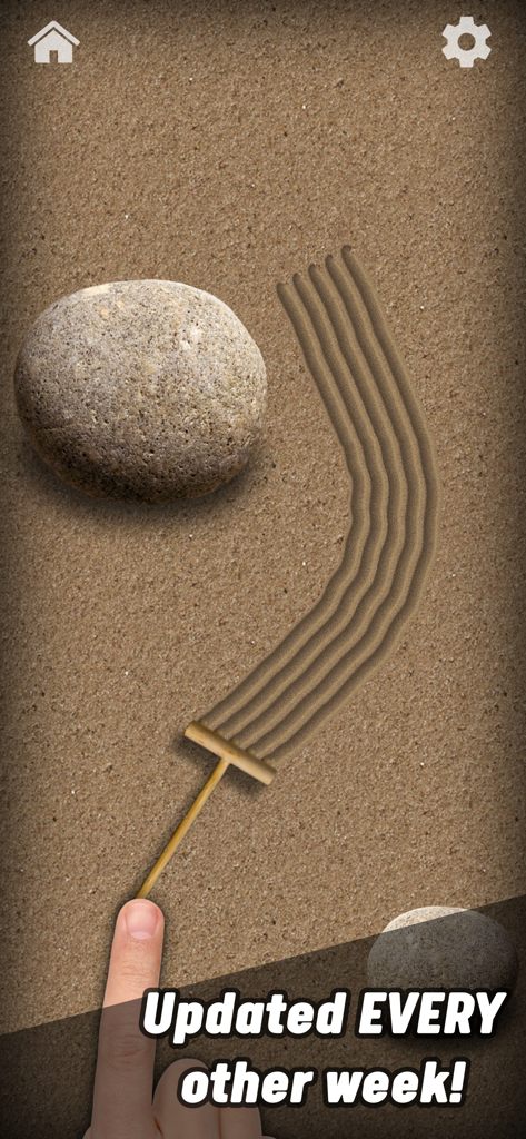 Zen garden sand toy with a rake and rock in the Antistress app