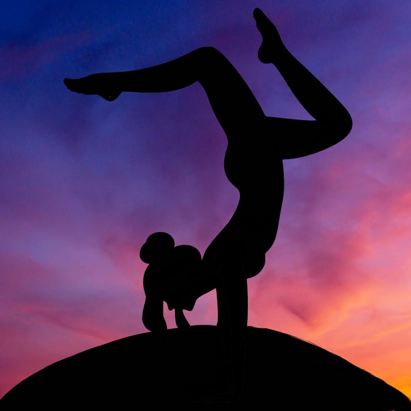 a woman doing a handstand