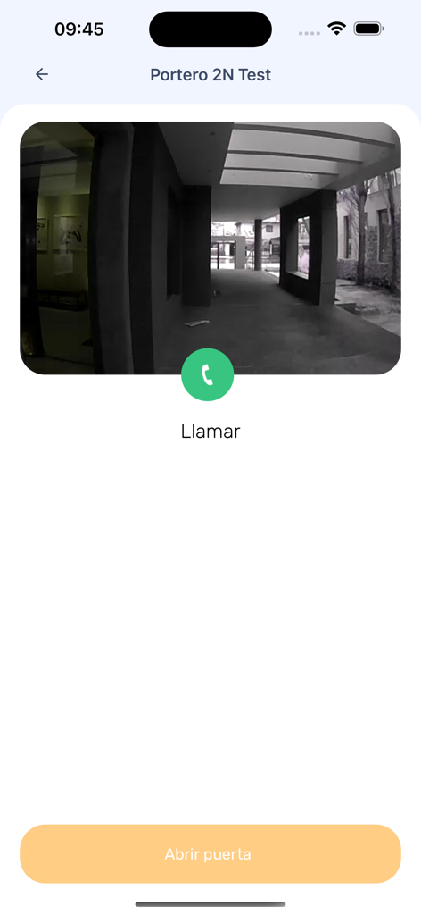 Interface of the Spotter app displaying a live video feed from a building intercom with buttons to call and remotely open the door.