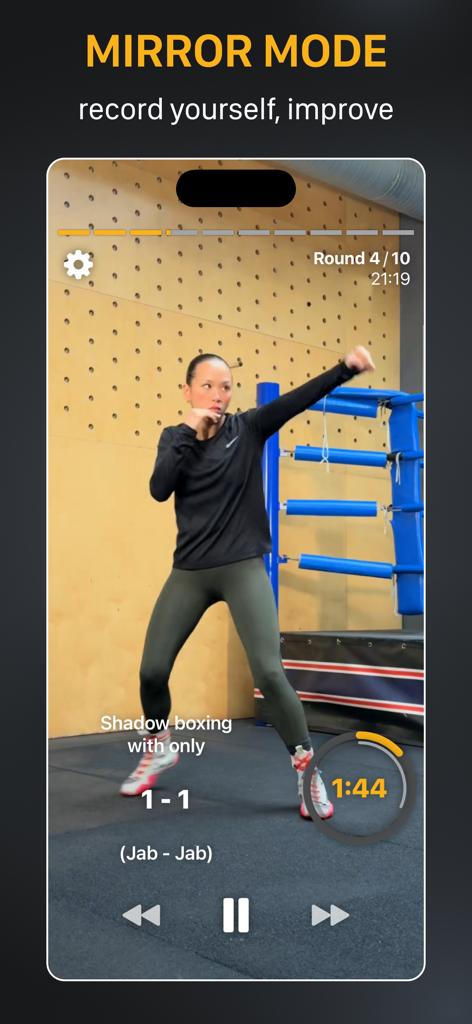 A woman using the mirror mode feature in the Shadow Boxing Workout App to record herself and improve her boxing technique