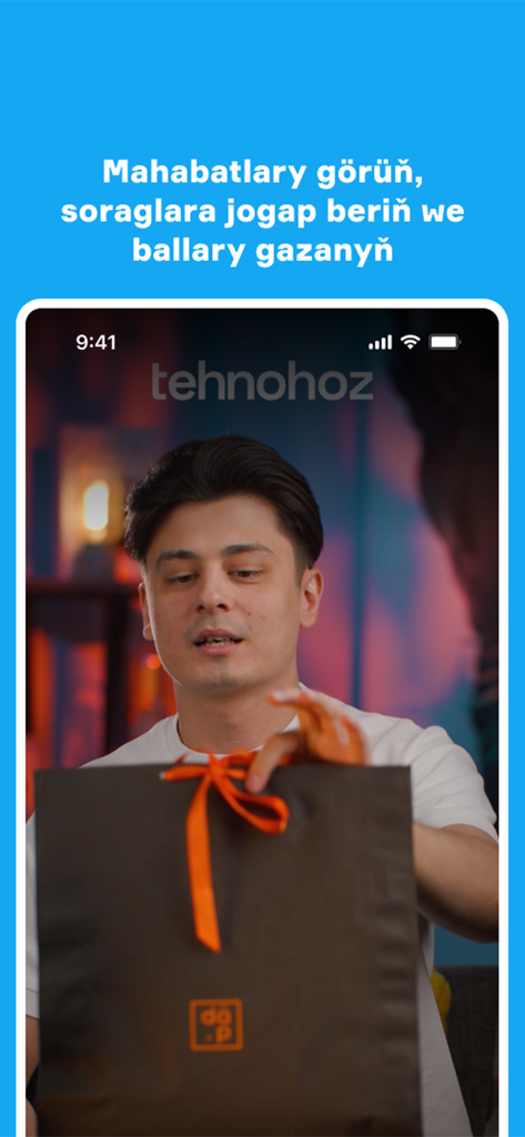 Netije - Screenshot of the Netije app showing a video of a man with a gift bag and Turkmen text explaining how to earn points by watching ads.