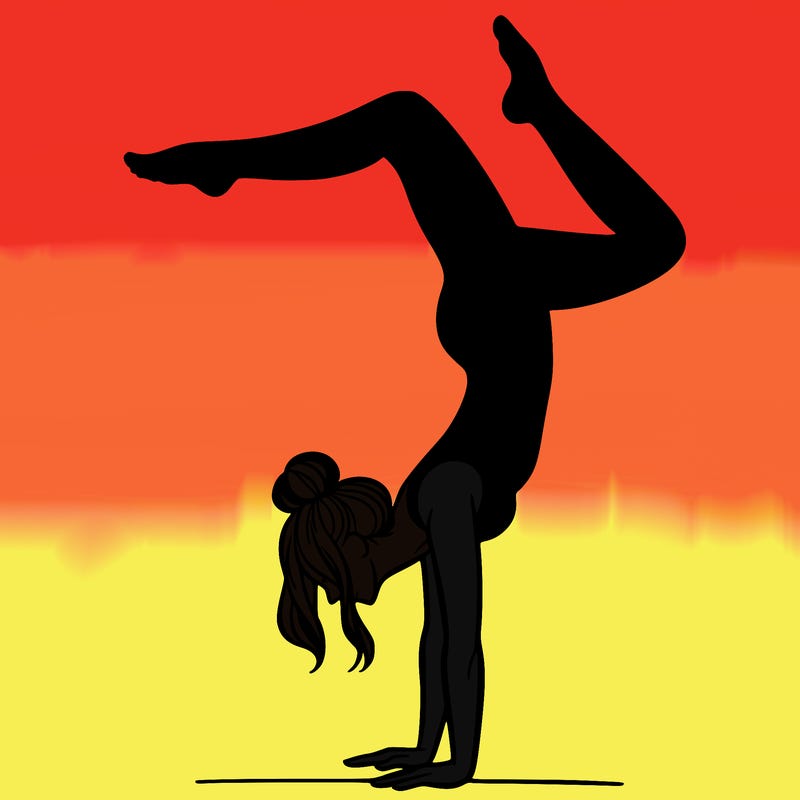 a woman doing a handstand