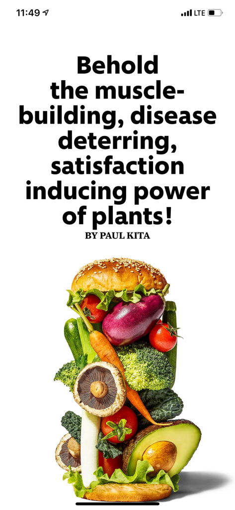 Artículo de la revista Men's Health sobre nutrición basada en plantas con una pila alta de verduras frescas en un pan de hamburguesa